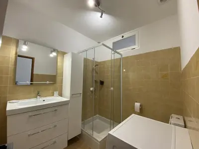 a bathroom with a shower and a sink and a mirror at Les Roches de Figa in Conca