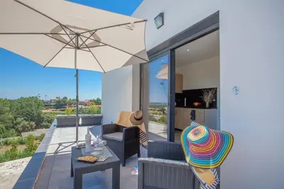 a patio with a table and an umbrella at Casa Dolce Vita in Borgo