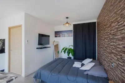 a bedroom with a blue bed and a brick wall at Casa Dolce Vita in Borgo