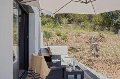 a patio with two chairs and an umbrella at Casa Dolce Vita in Borgo