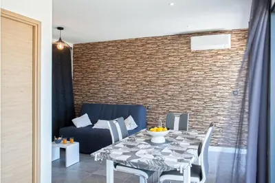a dining room with a table and a couch at Casa Dolce Vita in Borgo