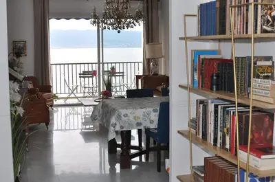 a dining room with a table and a view of the ocean at AJACCIO VUE MER, 3 chambres, 6 personnes in Ajaccio