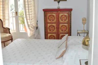 a bedroom with a bed and a wooden cabinet at AJACCIO VUE MER, 3 chambres, 6 personnes in Ajaccio