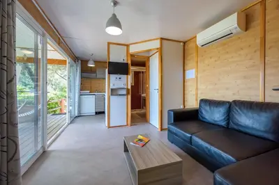 a living room with a couch and a table at Camping U Pirellu in Porto-Vecchio
