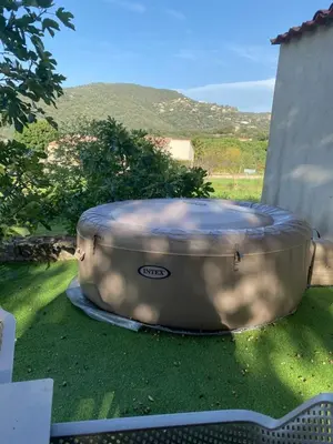a hot tub sitting on the grass in a yard at Les Bergeries in Ajaccio