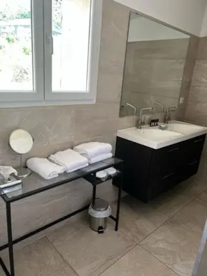 a bathroom with a sink and a mirror at Les Bergeries in Ajaccio
