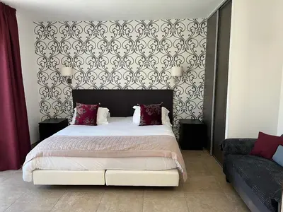a bedroom with a bed with a black and white headboard at Les Bergeries in Ajaccio
