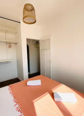 a dining room with a table and a lamp at Appartement Bonaparte centre ville d'Ajaccio in Ajaccio
