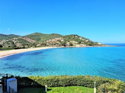 a view of a body of water with a beach at Résidence Les Pavillons du Golfe in Favone