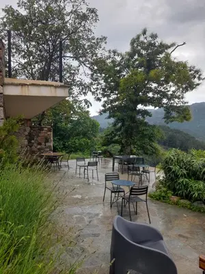 a group of tables and chairs sitting on a patio at Chambres d'Hôtes Villa Cardellini in Aullène