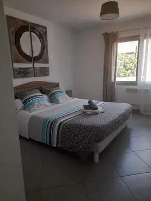 a bedroom with a bed and a window at Chambres d'Hôtes Villa Cardellini in Aullène