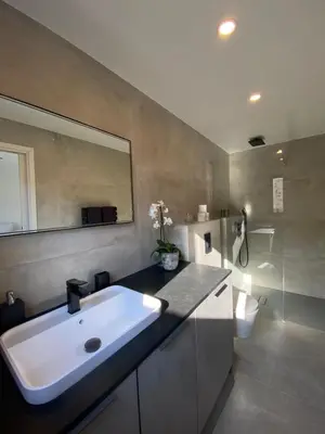 a bathroom with a white sink and a mirror at La Verda in Bonifacio