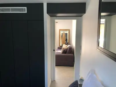 a hallway with a living room with a couch at La Verda in Bonifacio