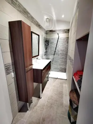 a bathroom with a sink and a shower at Indè Noi - Maison de village proche commodités in Murato