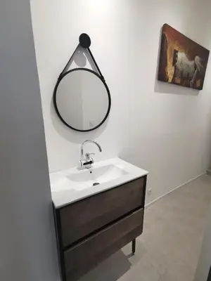 a bathroom with a sink and a mirror on the wall at Indè Noi - Maison de village proche commodités in Murato