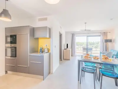 a kitchen and dining room with a table and chairs at Apartment Stanatura-4 by Interhome in Porto-Vecchio
