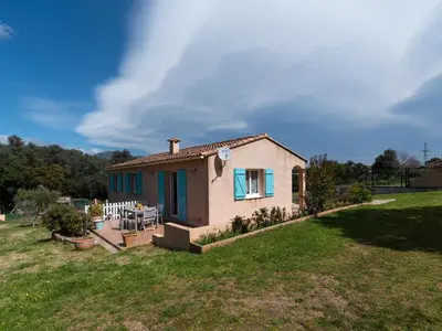 a small house in a field with a yard at Villa Les Rosiers by Interhome in Porto-Vecchio