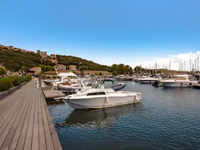 a street with tables and chairs in front of a store at Villa Les Rosiers by Interhome in Porto-Vecchio