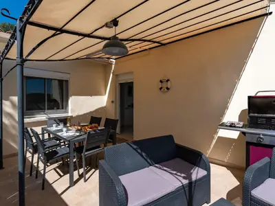 an outdoor patio with a table and chairs and a ceiling at Holiday Home Pietralunga 8 by Interhome in Sotta