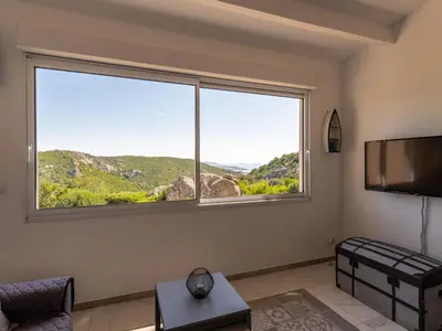 a living room with a large window and a couch at Holiday Home Pietralunga 8 by Interhome in Sotta