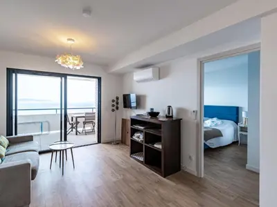 a living room with a couch and a bed and a table at Apartment La Spelunca by Interhome in Cargèse