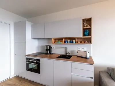 a kitchen with white cabinets and a counter top at Apartment La Spelunca by Interhome in Cargèse