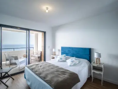 a bedroom with a bed and a view of the ocean at Apartment La Spelunca by Interhome in Cargèse