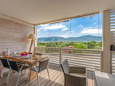 a dining room with a table and chairs and a large window at Apartment Résidence Cita Di Sali 12 by Interhome in Porto-Vecchio