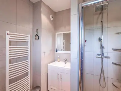 a white bathroom with a shower and a sink at Apartment Résidence Cita Di Sali 12 by Interhome in Porto-Vecchio