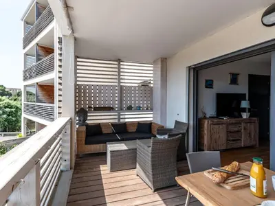 a living room with a couch and a table at Apartment Résidence Cita Di Sali 12 by Interhome in Porto-Vecchio