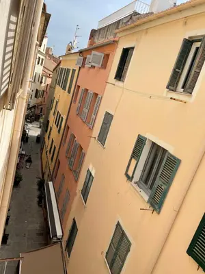 an alley between two buildings with green shutters at Ajaccio : appartement centre historique in Ajaccio
