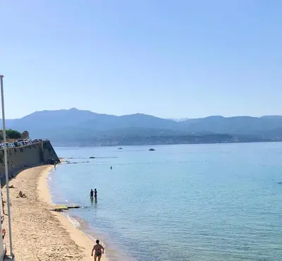 a group of people standing on a beach at Ajaccio : appartement centre historique in Ajaccio