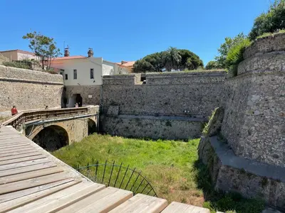 an old stone wall with a bridge and a walkway at Ajaccio : appartement centre historique in Ajaccio