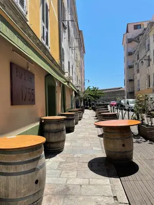 a row of wine barrels on a sidewalk next to a building at Ajaccio : appartement centre historique in Ajaccio