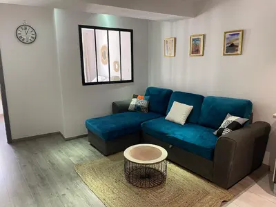 a living room with a blue couch and a table at Ajaccio : appartement centre historique in Ajaccio