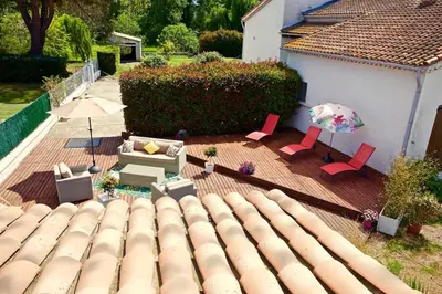 an aerial view of a patio with chairs and an umbrella at Campo Vecchio Dracena et Piscine in Ghisonaccia