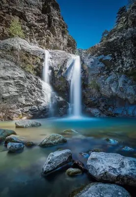 a waterfall in a river with rocks at Campo Vecchio Dracena et Piscine in Ghisonaccia