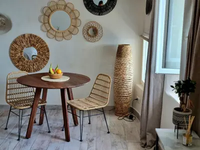 a dining room with a table and chairs and mirrors at Mare è rocca in Bonifacio