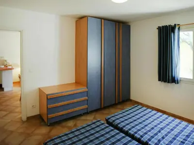 a living room with a bed and a table at Apartment in Corsica with Beach Access in Borgo