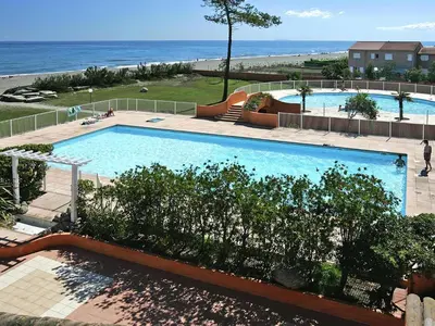 a yellow house with red shutters and trees at Apartment in Corsica with Beach Access in Borgo