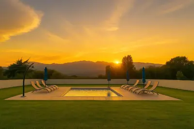 a group of chairs with umbrellas and a pool at Campo Vecchio Kamerops et piscine in Ghisonaccia