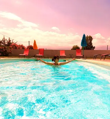 a person swimming in a swimming pool at Campo Vecchio Kamerops et piscine in Ghisonaccia