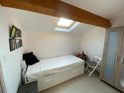 a small bedroom with a bed and a window at Les Canali in Santo-Pietro-di-Tenda