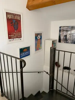 a staircase in a room with posters on the wall at Les Canali in Santo-Pietro-di-Tenda
