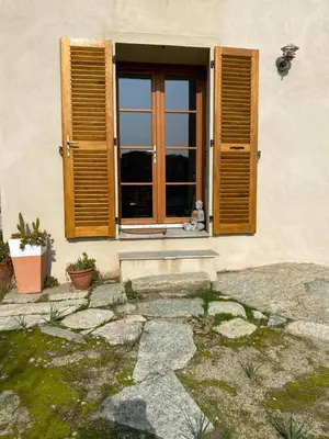 a window with a teddy bear sitting on a window sill at Les Canali in Santo-Pietro-di-Tenda