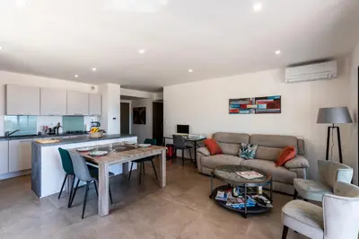 a living room with a couch and a table at L'Aurore de Cruciata - Appt vue baie d'Ajaccio in Pietrosella