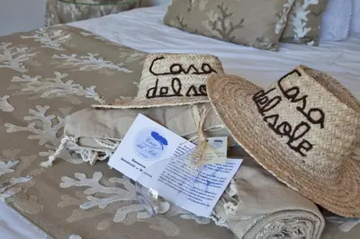 a bed with a blanket and pillows on it at Casa del Sole Chambres d'Hotes de Charme in Favone