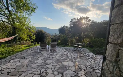 two chairs and a table on a stone patio at DOMAINE CARDU in Cardo-Torgia