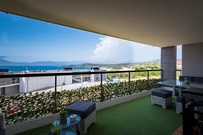 a balcony with plants and a view of the ocean at L'étincelle de Stagnola - Vue mer in Pietrosella