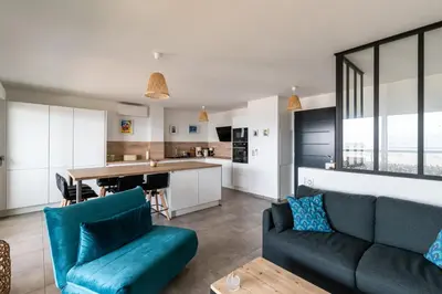 a living room with a couch and a kitchen at L'étincelle de Stagnola - Vue mer in Pietrosella